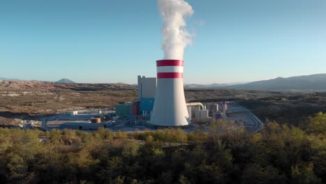 drone smoke from a coal fired power station dolly panning right sunset blue sky