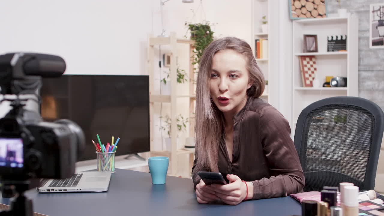 Woman filming a beauty vlog with professional camera
