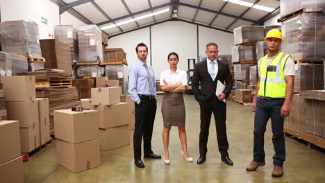 warehouse managers and worker posing