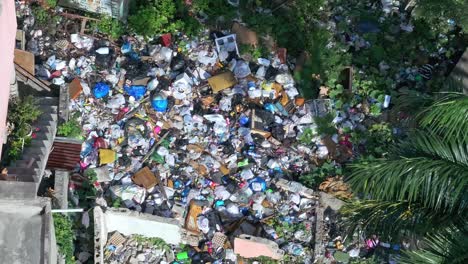 aerial, large pile of trash bags poor slum neighborhood, illegal disposal