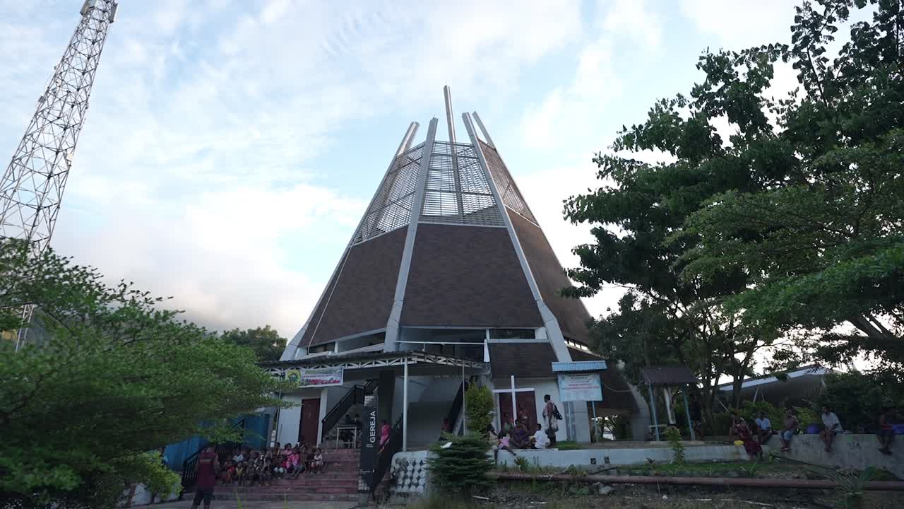 Modern Church Building with Unique Architecture and People Gathering Outside