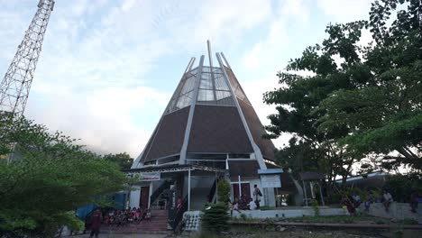 modern church building with unique architecture and people gathering outside