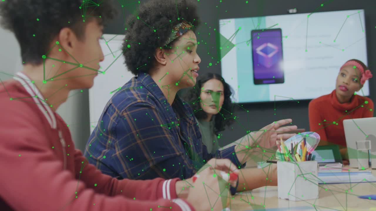 Team discussing tech project as network graphics overlaying mockup and speaker pointing at screen