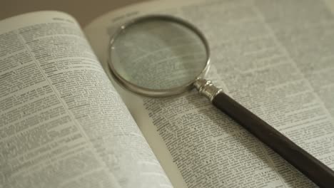 magnifying glass on large opened book