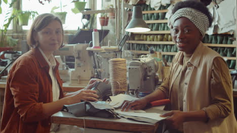 portrait of two female colleagues at work in shoemaking workshop