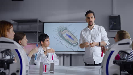 a teacher explaining a lesson about bacteria to students in a biology class