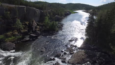 overflying a picturesque rushing waterfall in rugged backcountry