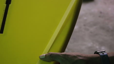 shaper hands marking tape to separate surface that is about to be painted