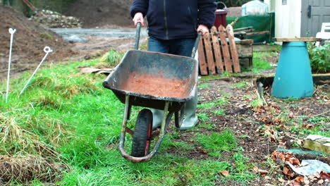 man pushing a wheelbarrow