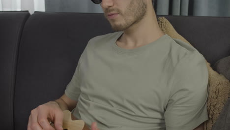 close up view of young blind man sitting on a sofa