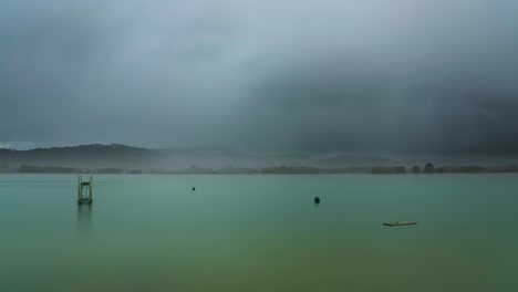 rain moves over a lake