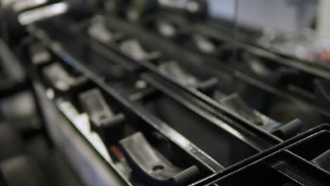 Close-up-of-male-hands-taking-two-dumbbells-in-the-gym