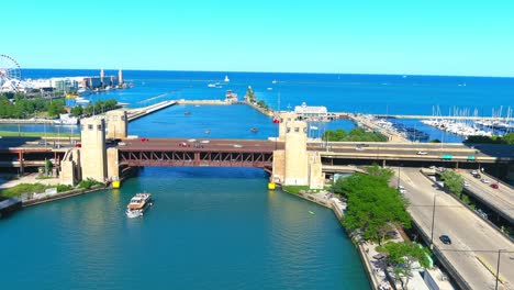 aerial flyby overlooking riverwalk and lake michigan in chicago illinois | navy pier in the background | afternoon lighting