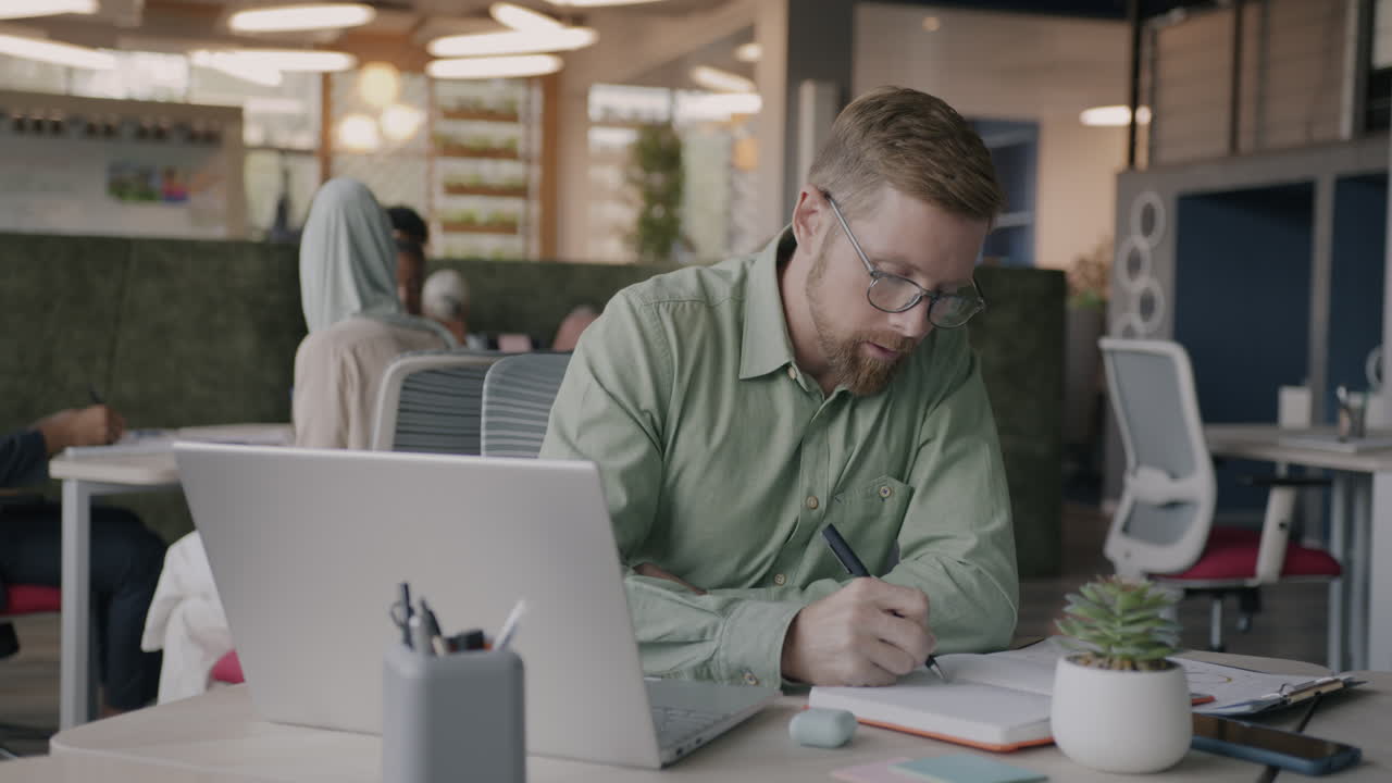 Man working on laptop in a modern office