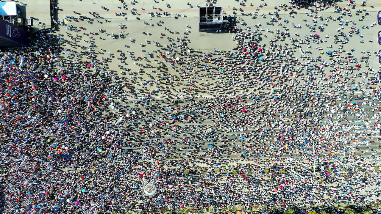 CHISINAU, MOLDOVA - 21 MAY, 2023: Aerial drone view of the rally in support of the country's European integration in Chisinau, Moldova. Thousands of people in the city downtown, greenery, EU and national flags