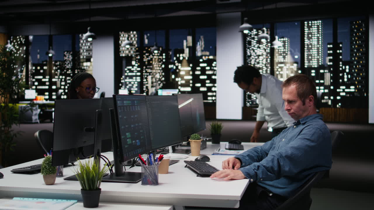 Man Working on Computer in Modern Office at Night