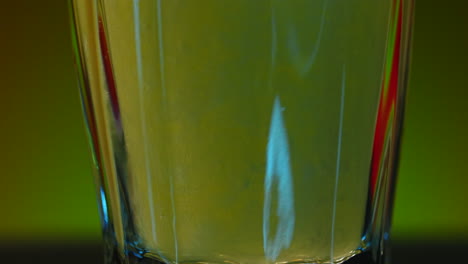 close up of a yellow liquid in a glass