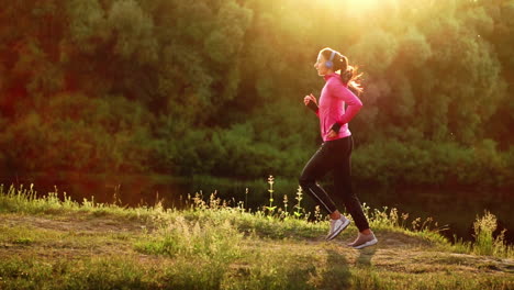 a morning jog in the park near the pond in the sunny rays of dawn, the girl is preparing to mariano and lead a healthy lifestyle