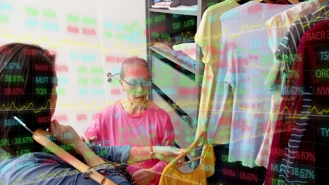 Adult woman pulling dress on rail, choosing outfit with seated senior, market tickers overlaying
