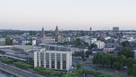 aerial lifting drone view of mainz dom, rheingoldhalle and cityscape at sunset germany 4k