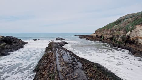 dramatic ocean cliffs on the west coast with waves crashing against rocks