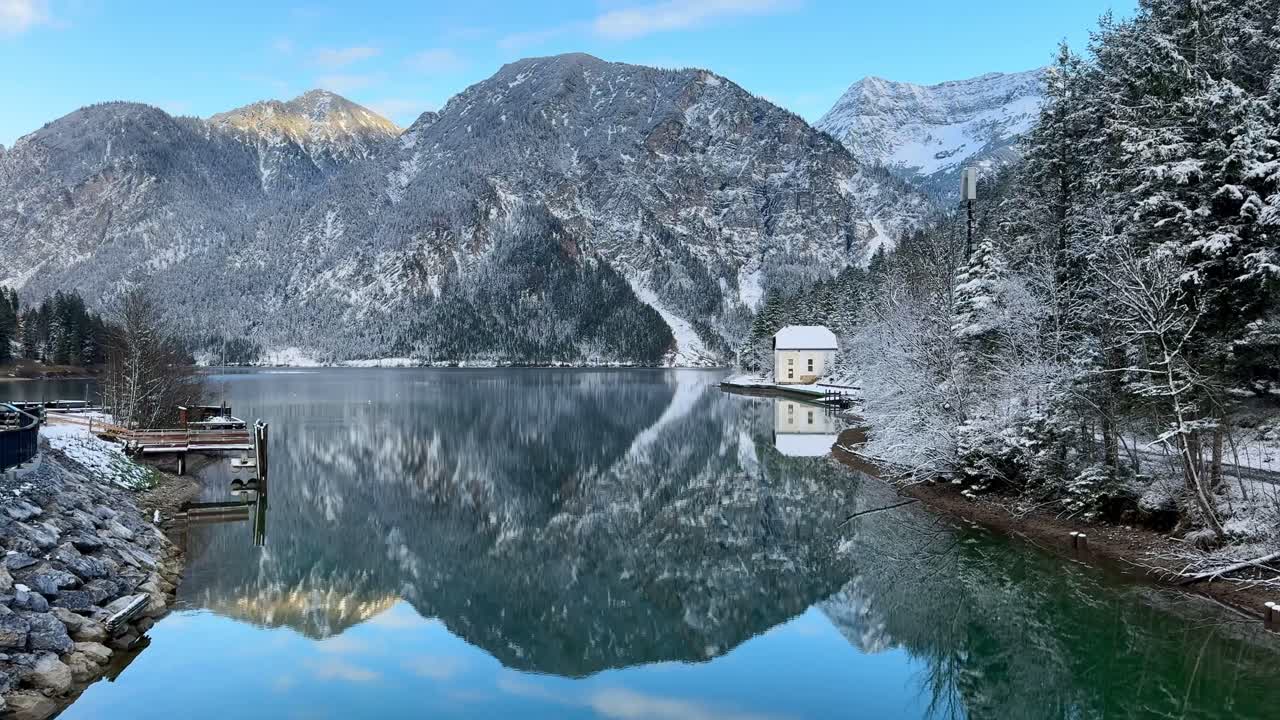 Plansee’s reflective lake showcase Austrian mountains.