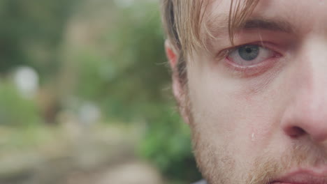 crying man sitting on bench, extreme close up