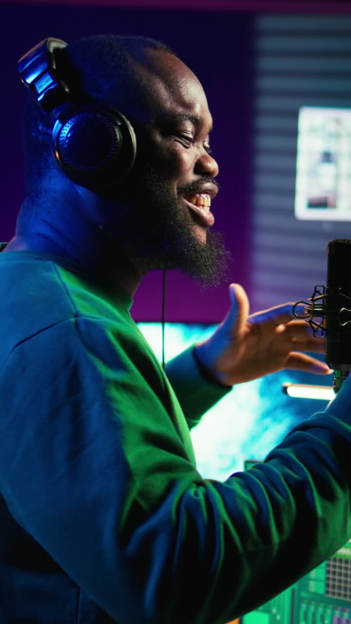 African American Man Singing into Microphone in Recording Studio