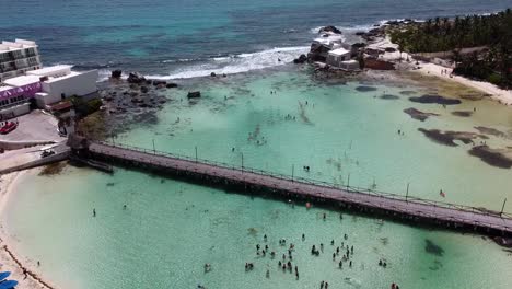 A-tilt-down-shot-of-a-wooden-bridge-at-Isla-Mujeres-in-Mexico