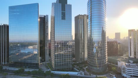 beautiful aerial landscape of buenos aires city with modern office buildings in downtown business district, big bright sun shinning in the background, pan shot