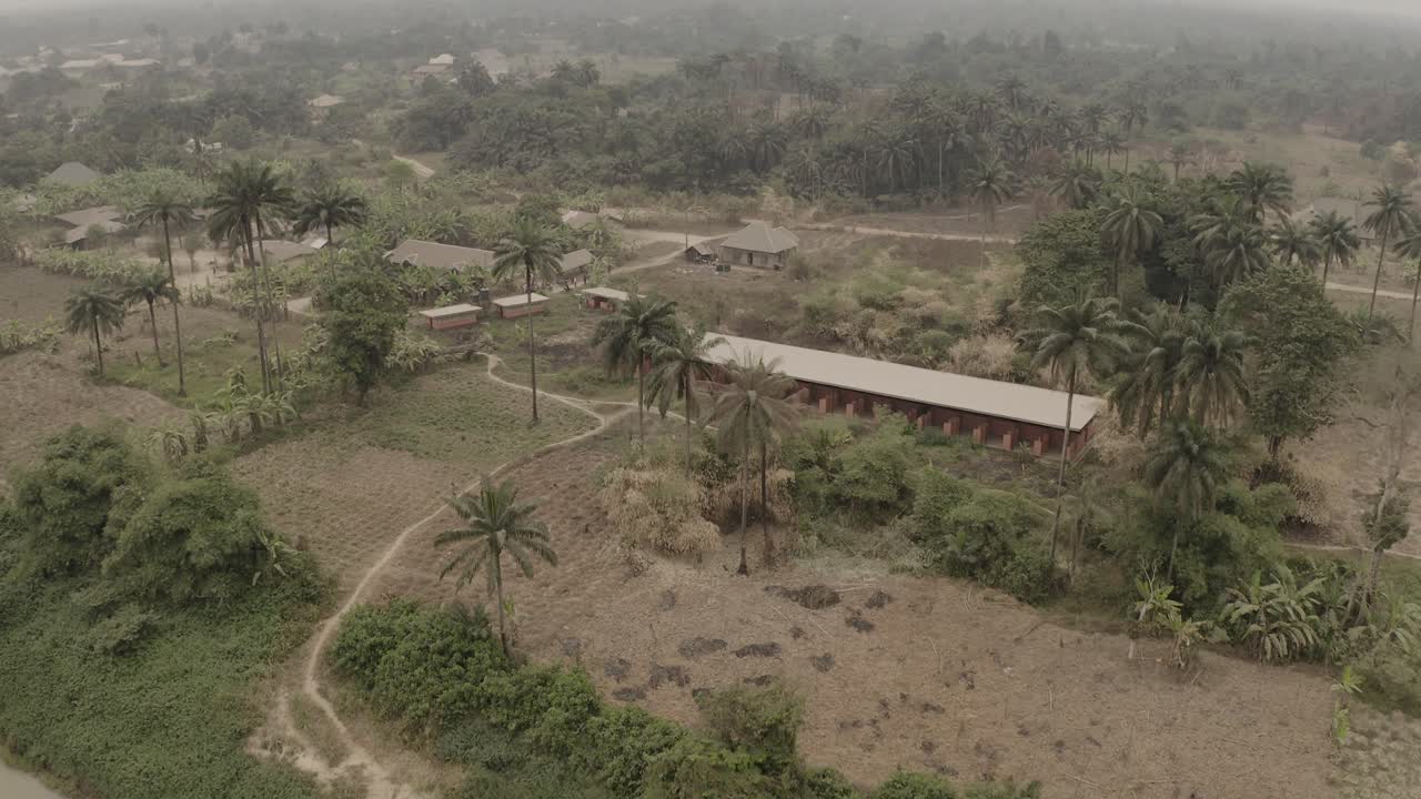 Aerial shot of coastal tropical community bordered by River Niger
