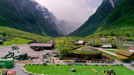 Green-valley-with-a-river-between-mountains-with-some-buildings-and-bridges