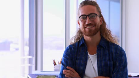 male architect standing with arms crossed in office 4k