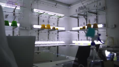 Cold-laboratory-with-bubbling-beakers-on-shelves-and-fluorescent-lighting