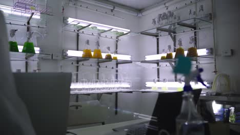 cold laboratory with bubbling beakers on shelves and fluorescent lighting