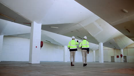 construction workers inspecting warehouse