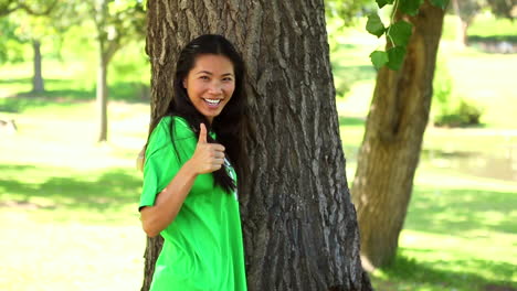 happy environmental activist hugging a tree