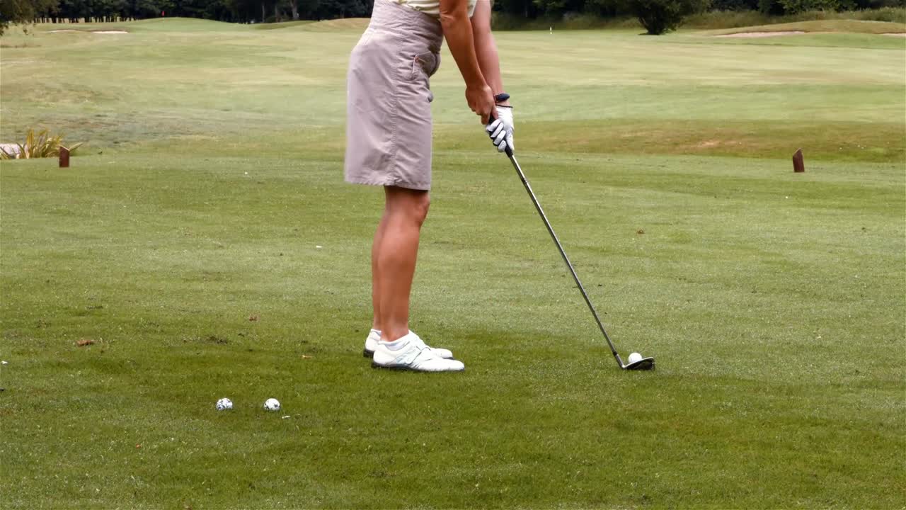 Donna concentrata che gioca a golf
