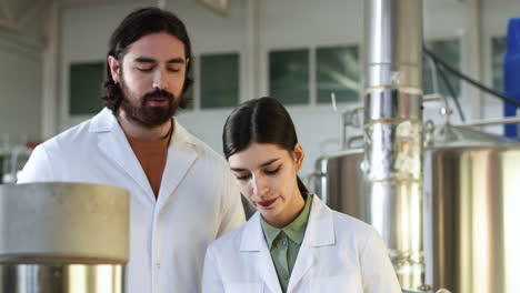 man and woman doing control at brewery