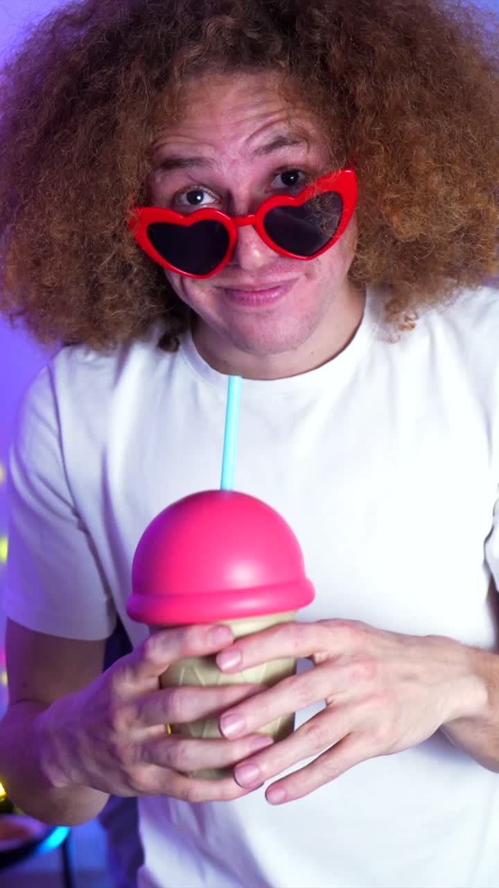 Man with Heart Sunglasses Drinking from Cup