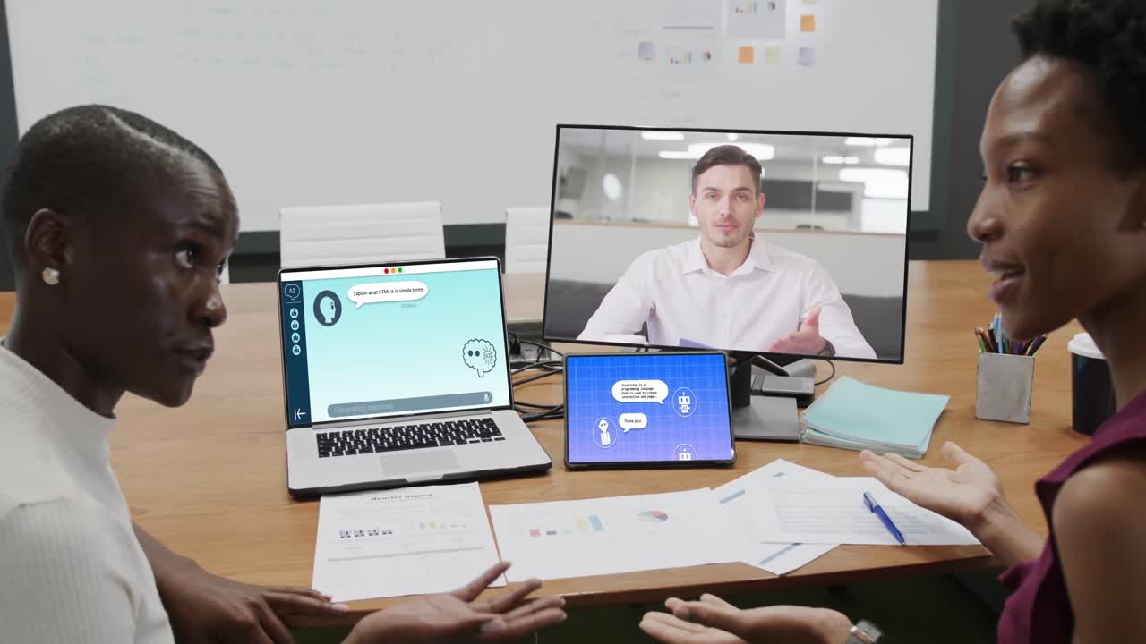 African american businesswomen on computer video call and talking in office