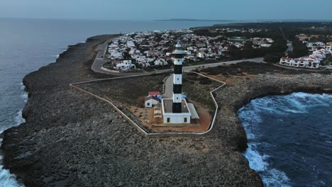 cinematic reveal of lighthouse on the edge of menora spain