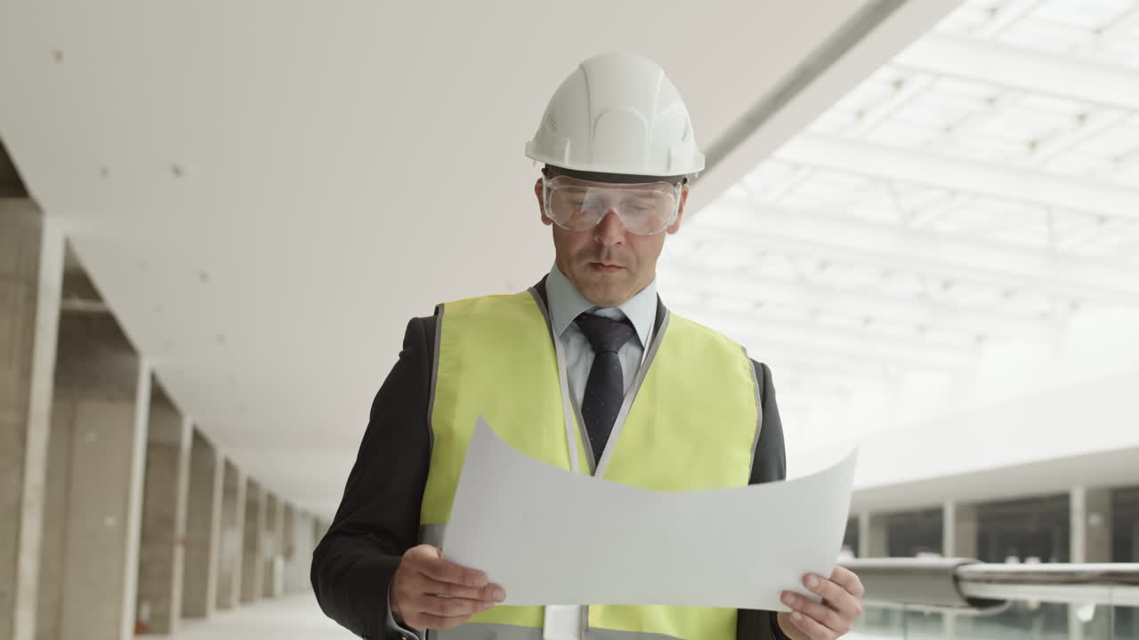 Builder with Paper Supervising Construction Site