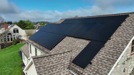 solar panels on roof of homes in american neighborhood during sunny day
