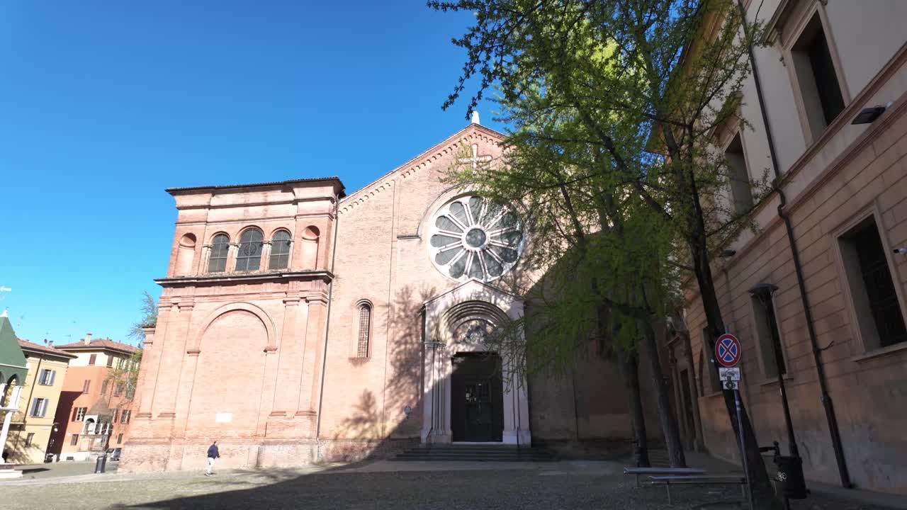 Historic Brick Church with Rose Window on a Cobbled Square