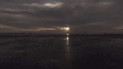 scenery of low tide at sunset, drone shot, low flying shot