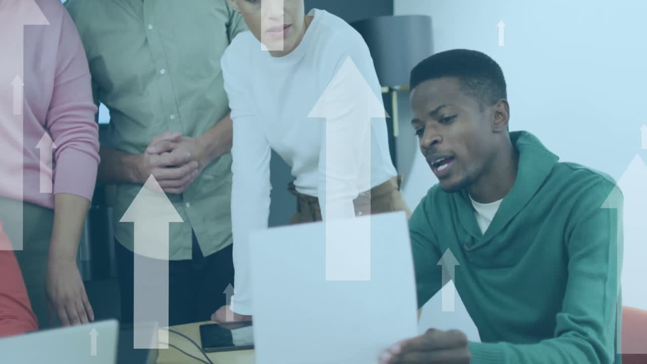 Animation of up arrows over diverse coworkers discussing reports on laptop at office