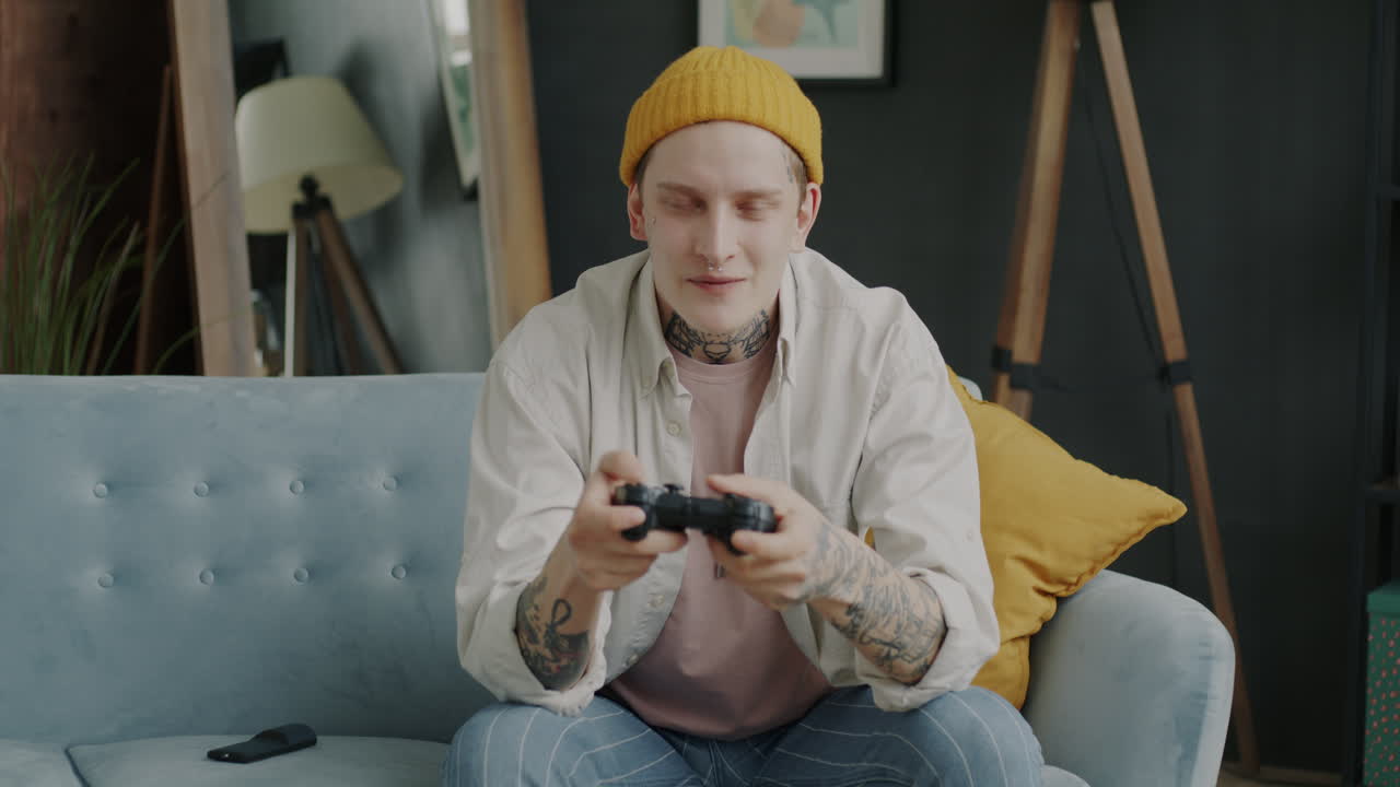 Young man gaming on a couch