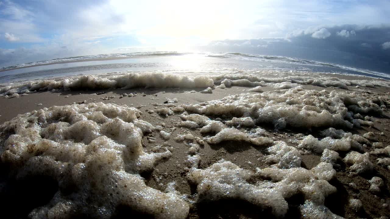 espuma de algas en tormenta en la playa, playa de arena con olas, mar del norte, jutlandia, sondervig, dinamarca, 4k
