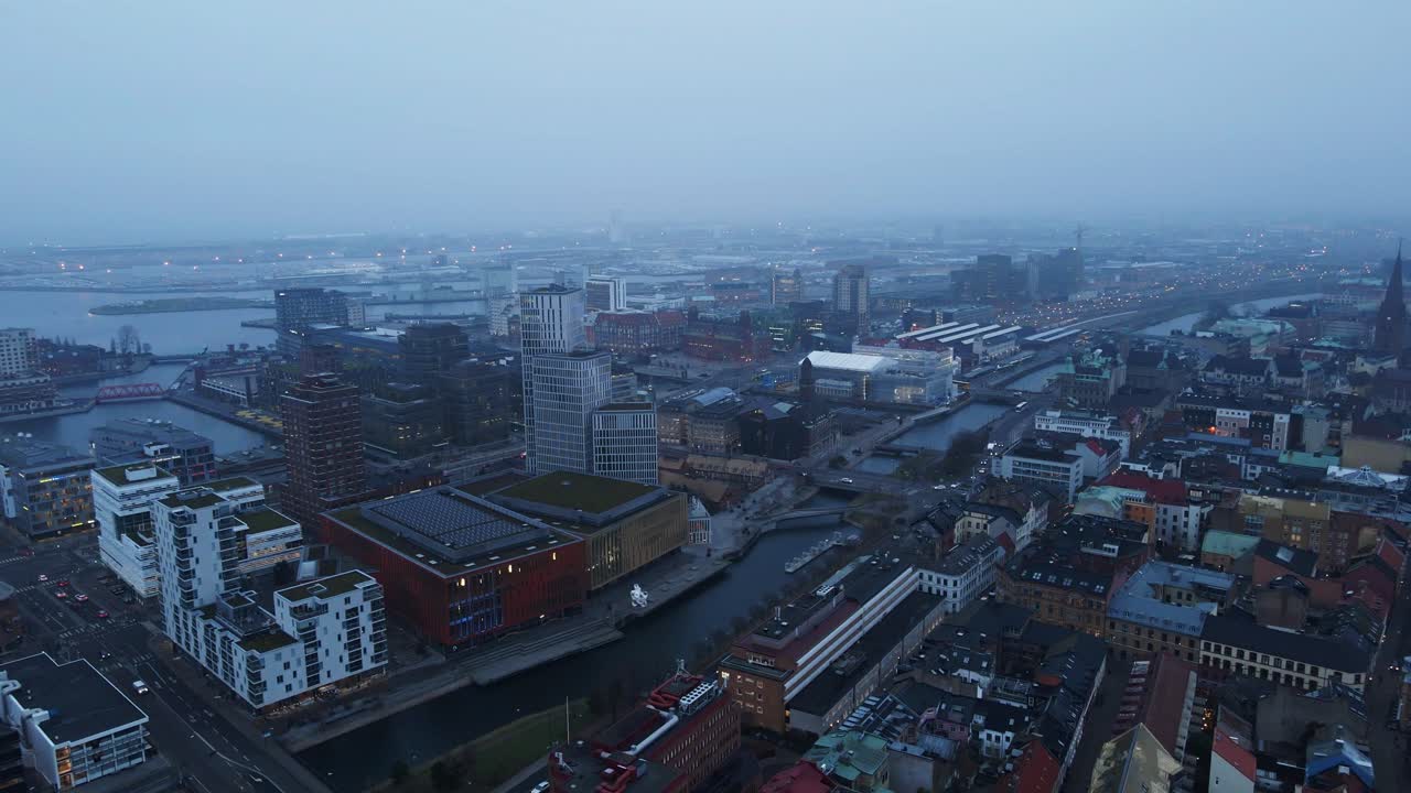 Beautiful aerial of the modern part of Malmö, Sweden on a foggy morning. The Clarion Hotel high rise building can be seen on the other side of the river
